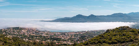 Panoramic view of a cloud inversion over the citadel and bay of Calvi in the Balagne region of Corsicaの写真素材