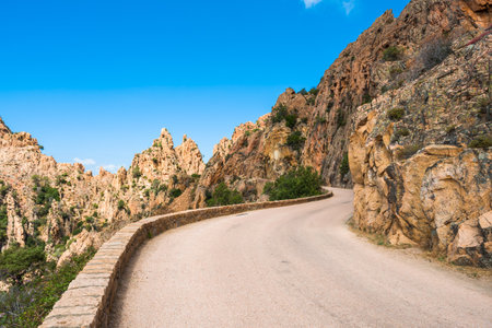 The D81 road through the dramatic rock formations at the Calanques de Piana on the west coast of Corsicaの写真素材
