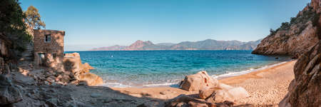 Panoramic view of a derelict building on the small secluded beach of Ficaghiola and turquoise Mediterranean sea on the west coast of Corsicaの写真素材