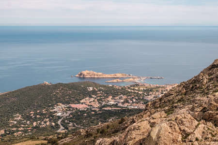 View of La Pietra, the red rock of Ile Rousse, on the coastline of the Balagne region of Corsicaの写真素材