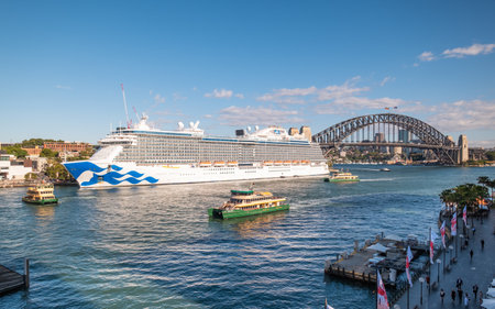 Circular Quay, Sydney, Australia - 8th December 2022: The cruise ship Majestic Pricess of Princess Cruises is moored at Circular Quay in Sydney, Australia, as ferries arrive and depart with the Harbour Bridge in the distance.