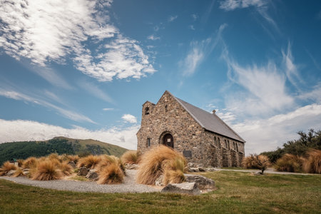 Wispy clouds and blue sky behind the Church of the Good Shepherd on the banks of Lake Tekapo in New...