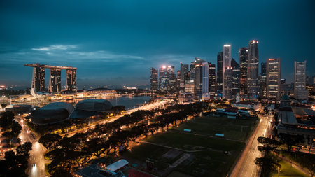Singapore City, Singapore - 2nd December 2022: Dawn breaking over the central business district and Marina Bay in Singapore with Singapore cricket club in the foregroundのeditorial素材