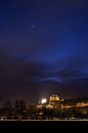 Beynac-et-Cazenac, France - 6th May 2024: Nightfall over Chateau de Beynac in the Dordogne region of France with light trails from cars in the foregroundのeditorial素材
