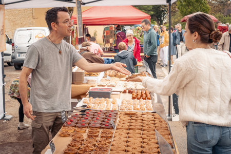 Nabirat, Nouvelle-Aquitaine, France - 12th May 2024: An artisan selling pastries and cakes at the annual strawberry fair, Foire de la Fraise, at Nabirat in the Dordogne region of Franceのeditorial素材