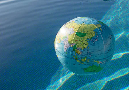 Plastic, inflatable globe floating in a swimming pool. Close up.