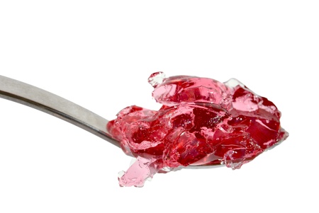 Metal spoon with pink jelly isolated on white backgroundの写真素材