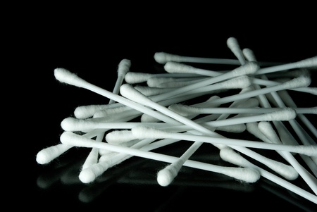White cotton buds isolated on black background