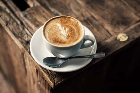 Cappuccino Coffee on Rustic Wooden Tableの写真素材