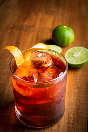 a red cocktail sour drink with limeの写真素材