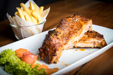 pork ribs with honey glazed shine and begium friesの写真素材