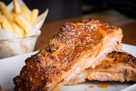 pork ribs with honey glazed shine and begium friesの写真素材
