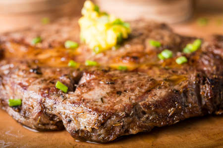 Beef steak served with mashed potato and gravy with melting butterの写真素材