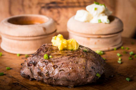 Beef steak served with mashed potato and gravy with melting butterの写真素材