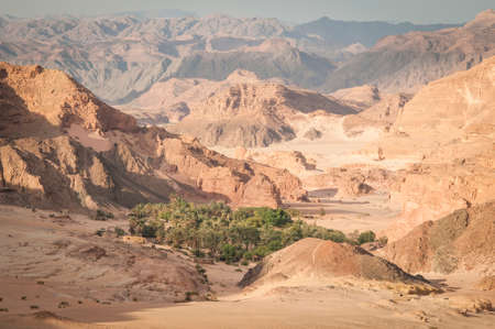Desert landscape with blue sky and sun with sand and mountainsの写真素材