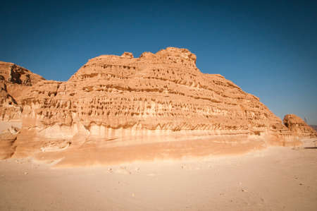 Desert landscape with blue sky and sun with sand and mountainsの写真素材