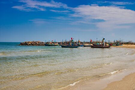 In this unique photo you can see the beach of Thailand with traditional wooden fishing boats!の写真素材