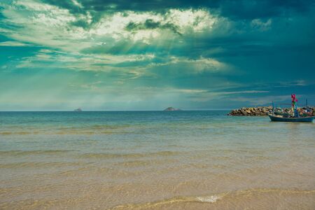In this unique photo you can see the beach of Thailand with traditional wooden fishing boats!の写真素材