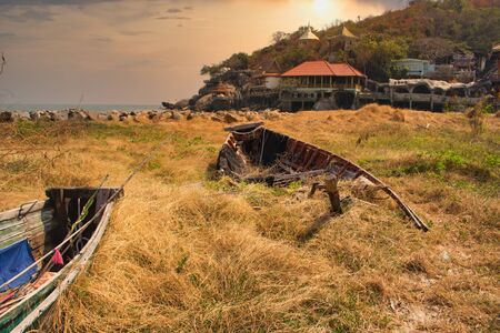 In this unique photo you can see an old broken wooden fishing boat that recovers nature!の写真素材