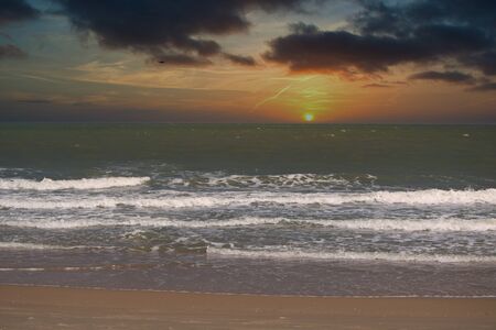 This unique photo shows beautiful cloudy orange sunset on the beach in Thailand!の写真素材