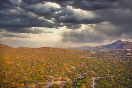 This unique photo shows the nature landscape with trees and hills from above with a unique cloudscape in the sunset in Hua Hin Thailand.の写真素材