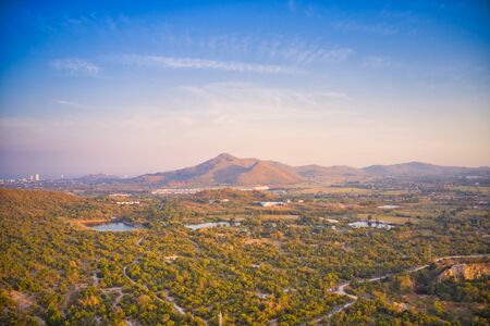 This unique photo shows the nature landscape with trees and hills from above with a unique cloudscape in the sunset in Hua Hin Thailand.の写真素材