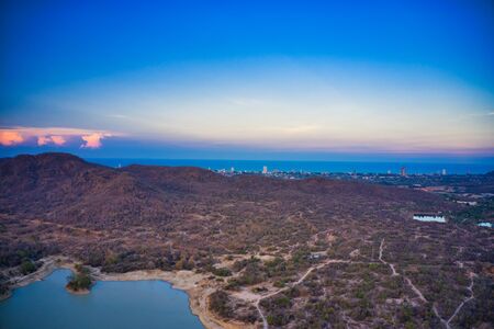 This unique photo shows the back landscape of Hua Hin in Thailand with a sunset in the background you can see the city located by the sea!の写真素材