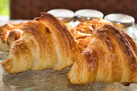 This unique photo of the super delicious gold yellow croissants lying on a breakfast plate! the picture was taken in thailandの写真素材
