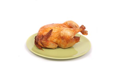 chicken on the green plate on the white backgroundの写真素材