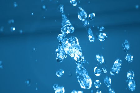 drops of water in the air in the blue color の写真素材