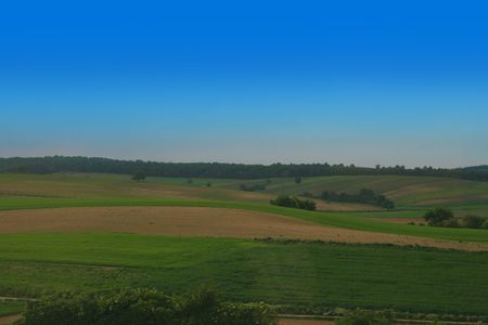 czech country with green grass and blue sky の写真素材