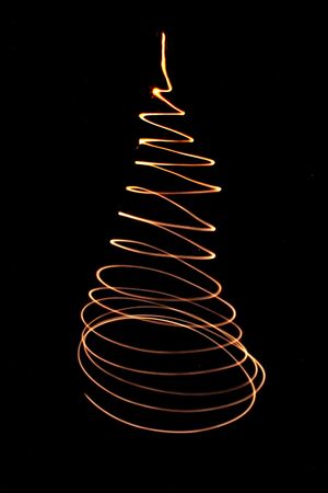 xmas tree from the lights on the black backgroundの写真素材