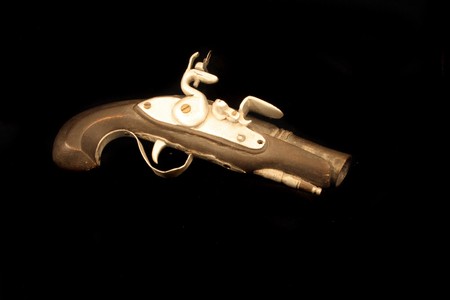 very old gun on the black baclgroundの写真素材