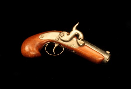 very old gun on the black baclgroundの写真素材