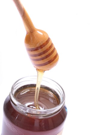 sweet fresh honey on the white background の写真素材