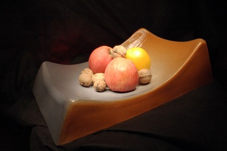 aplle, orange and nuts on the black backgroundの写真素材