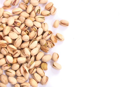 fresh salted pitachios on the white backgroundの写真素材