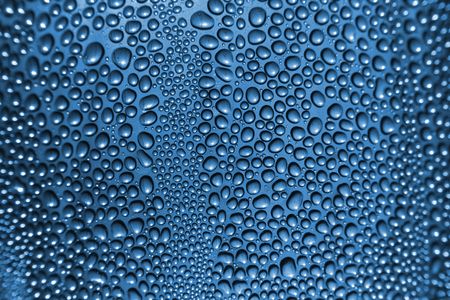 water drops texture on the glass in the blue colorの写真素材