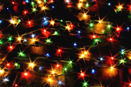 xmas background with color lights on the black backgroundの写真素材