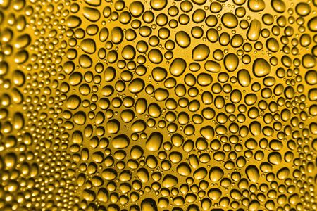 golden beer background with the water dropsの写真素材