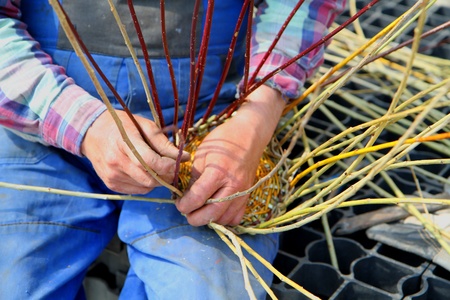 man is making traditional easter wicker basket の写真素材