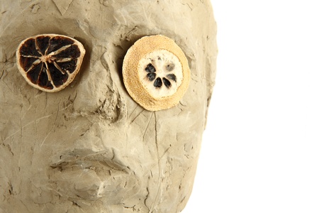 handmade statue with lemon eyes isolated on the white backgroundの写真素材