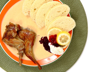carrot sauce with rabbit legs on white backgroundの写真素材