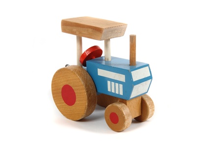 old wooden tractor toy isolated on the white backgroundの写真素材