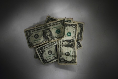 dollars in the dark night as financial backgroundの写真素材