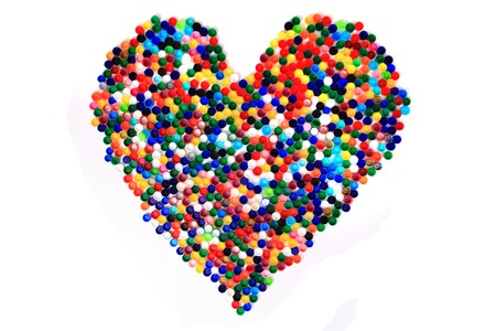 heart from color plastic caps isolated on the white の写真素材