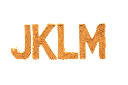 alphabet and numbers from the sand isolated on the white backgroundの写真素材