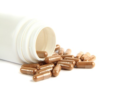 brown pills isolated on the white backgroundの写真素材