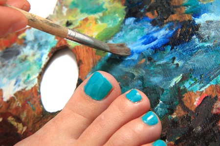 women feet (pedicure)  with color palette backgroundの写真素材