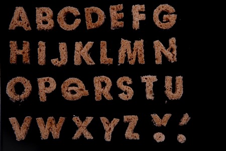 bread alphabet isolated on the black backgroundの写真素材